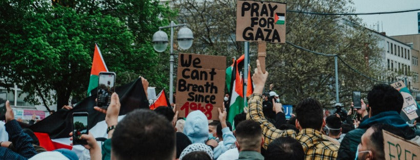 A powerful march in support of Palestine, featuring demonstrators holding "Free Palestine" banners. The image captures the solidarity and braveness of the Palestinian people in their pursuit of freedom and justice.