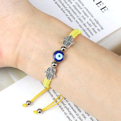 Envy's Gaze: Hamsa Pendant Bracelet